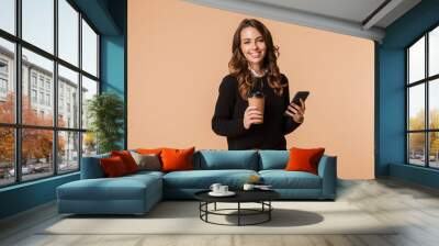 Smiling young woman wearing sweater standing Wall mural