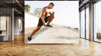 Strong mature sportsman make exercises Wall mural