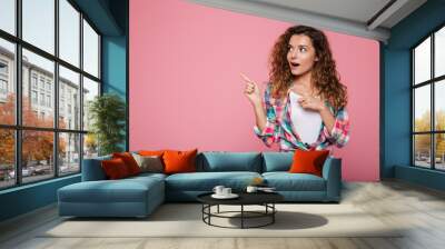 Surprised lady pointing at copy space isolated Wall mural