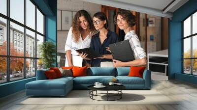 Three business women in co working office Wall mural