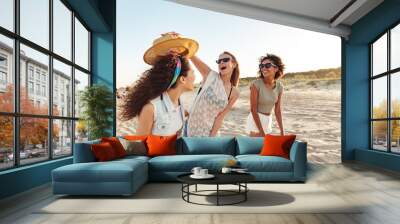 three excited girls friends in summer clothes Wall mural