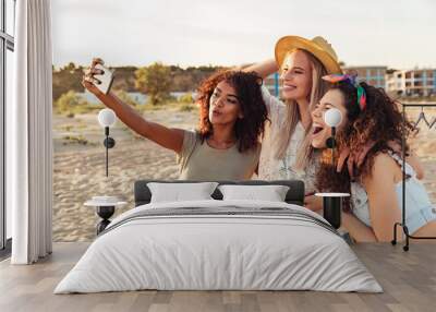 Three joyful girls friends in summer clothes Wall mural