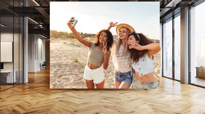 Three smiling girls friends in summer clothes Wall mural