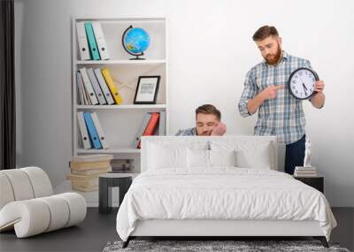 Tired businessman sleeping at his workplace Wall mural