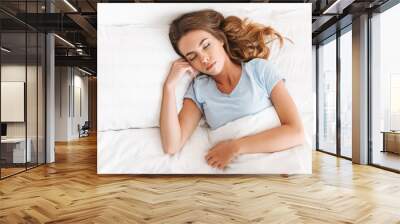 Top view of a pretty young woman sleeping Wall mural