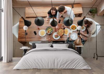 Top view of people having dinner together while sitting Wall mural