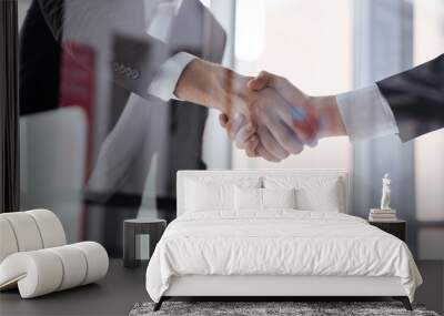 two businessmen standing and shaking hands in office Wall mural