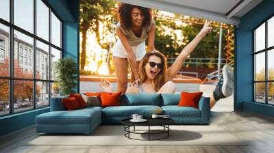 Two excited young girls having fun Wall mural