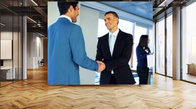 Two happy businessman handshaking in conference hall Wall mural