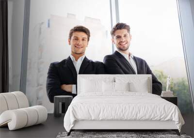 two happy businessmen standing with arms crossed in office Wall mural