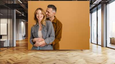 White happy couple wearing shirts laughing and hugging Wall mural