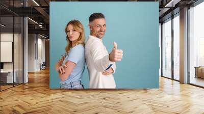 White man and woman standing back to back with different emotions Wall mural