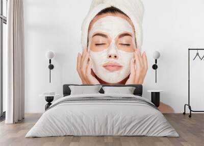 Woman with eyes closed and white facial mask on face Wall mural