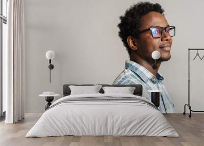 Young black man wearing eyeglasses posing and looking aside Wall mural