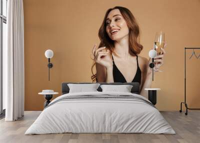 young happy woman looking away and smiling with champagne Wall mural