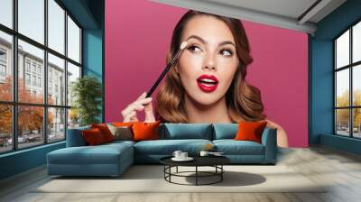 Young pretty lady making make up with brush for eyes isolated Wall mural