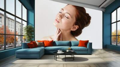 Young redhead woman posing isolated over white wall background. Wall mural