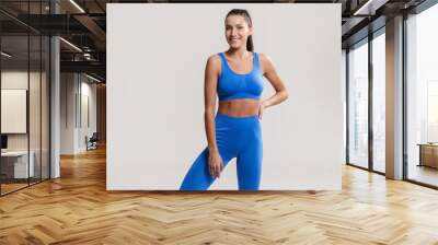 Young white fitness woman wearing sportswear Wall mural