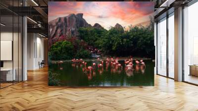 Pink flamingos on the lake against the backdrop of mountains and a beautiful sunset Wall mural