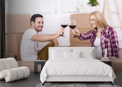 Young Couple Celebrating Moving In To New Home. Home, people, moving and real estate concept Wall mural