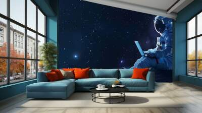 astronaut in space with a laptop with copy space Wall mural