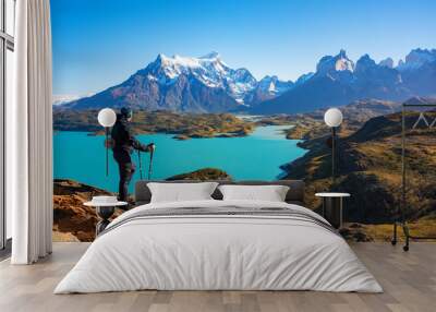 Hiker at mirador condor enjoying amazing view of Los Cuernos rocks and Lake Pehoe in Torres del Paine national park, Patagonia, Chile Wall mural