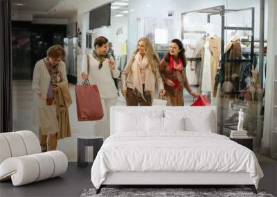 Happy beautiful senior women enjoying shopping together at the mall center Wall mural