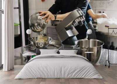 Making macarons. A silver kitchen table mixer kneads the dough for macarons. Wall mural