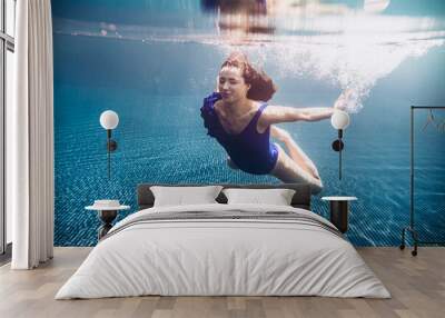 young beautiful woman swimming underwater. Wall mural