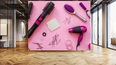 Professional hairdressing tools in pink colors on pink background Wall mural