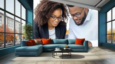 A business owner signing a loan agreement with a bank officer in a modern office setting Wall mural