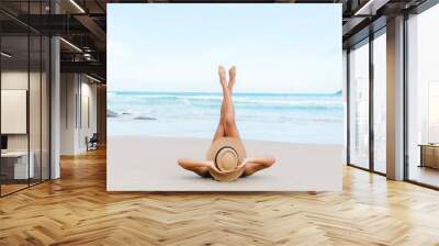 Greeting the day with sunny salutations, a joyful woman in a bikini engages in beach yoga, welcoming the positive energy and embracing the beauty of the beach. Wall mural