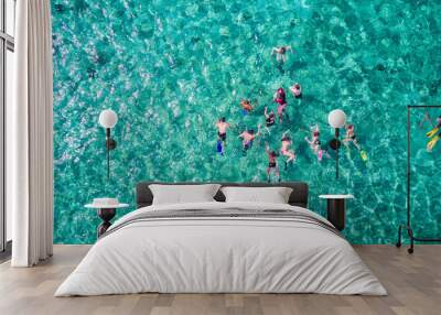 Aerial drone view of group of people snorkelling in tropical blue waters in the Caribbean Sea Wall mural