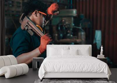 Engineer taking a break while working and wiping perspiration from his head with his safety gloves Wall mural