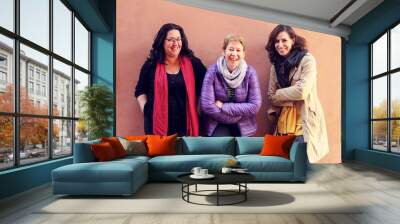  Women best friends smiling and walking at the city.  Outdoors lifestyle fashion portrait. Positive emotions. Wall mural