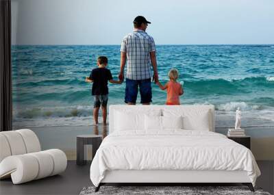 father with son and daughter  on vacation at sea Wall mural