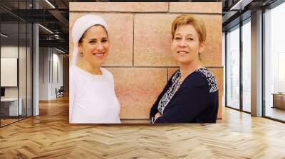 portrait attarctive mature women standing next to the wall Wall mural