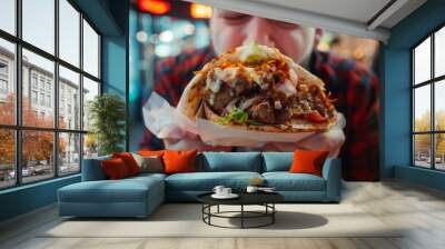 Eating giant fast food kebab, relishing a greasy and massive meal, ideal for anyone feeling very hungry and in need of a hearty dish Wall mural