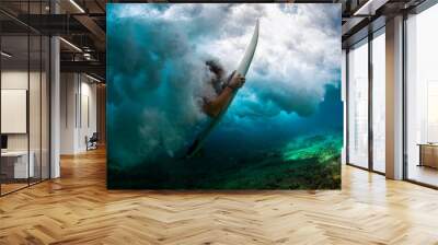 Underwater shot of the male surfer trying to get out from the broken wave Wall mural