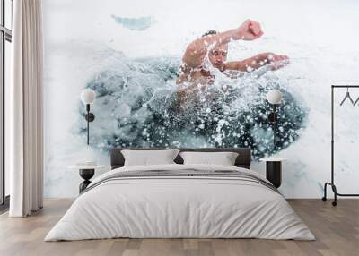 Young man haves recreational winter swim in the lake Wall mural