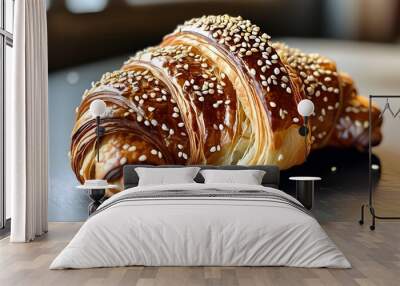 Delicious close-up of homemade croissant bread topped with sesame seeds, showcasing a tempting golden texture Wall mural