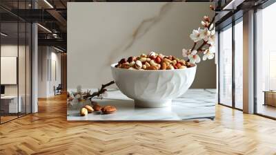 Serene minimalist display of white porcelain bowls filled with assorted nuts beside blossoming flowers on a marble countertop Wall mural