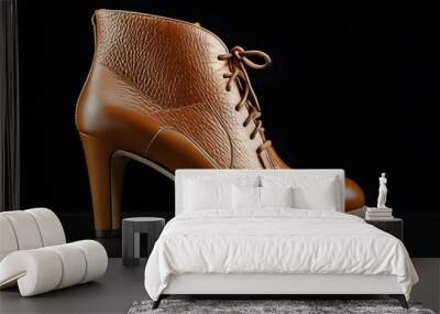 Stylish tan leather heeled ankle boots showcased against a sleek black backdrop Wall mural