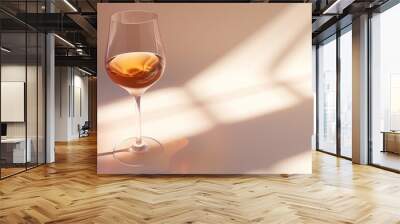 A wine glass, full of wine on a white surface, in a light brown and white style. Wall mural