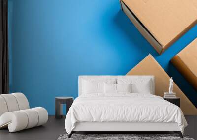 Cardboard boxes on a blue background from a top angle, with space in the right corner for text. Wall mural