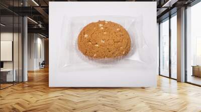 Oatmeal cookie in a plastic pack on a white Wall mural