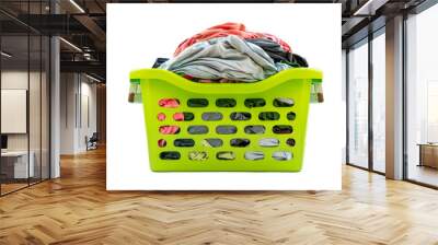 Isolated used cloth in plastic basket on white background, front view of green basket, clothes full in basket. Wall mural