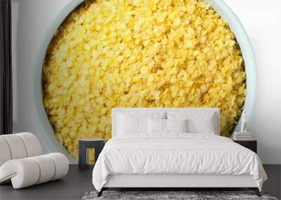 Millet flakes in bowl isolated on white background, top view Wall mural