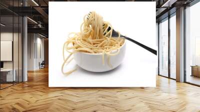 Swirls of cooked spaghetti with fork in bowl isolated on white Wall mural