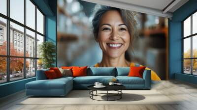 A joyful woman wearing an orange vest beaming with positivity works energetically in a busy warehouse, showcasing enthusiasm and efficiency in industrial environments. Wall mural